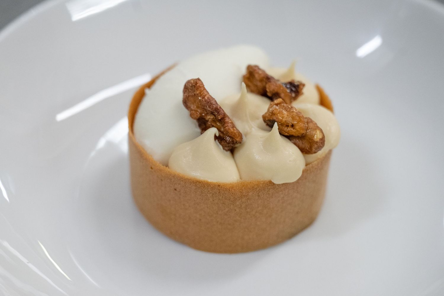 Elegant plated desserts on white dishes showing artistic culinary presentation.