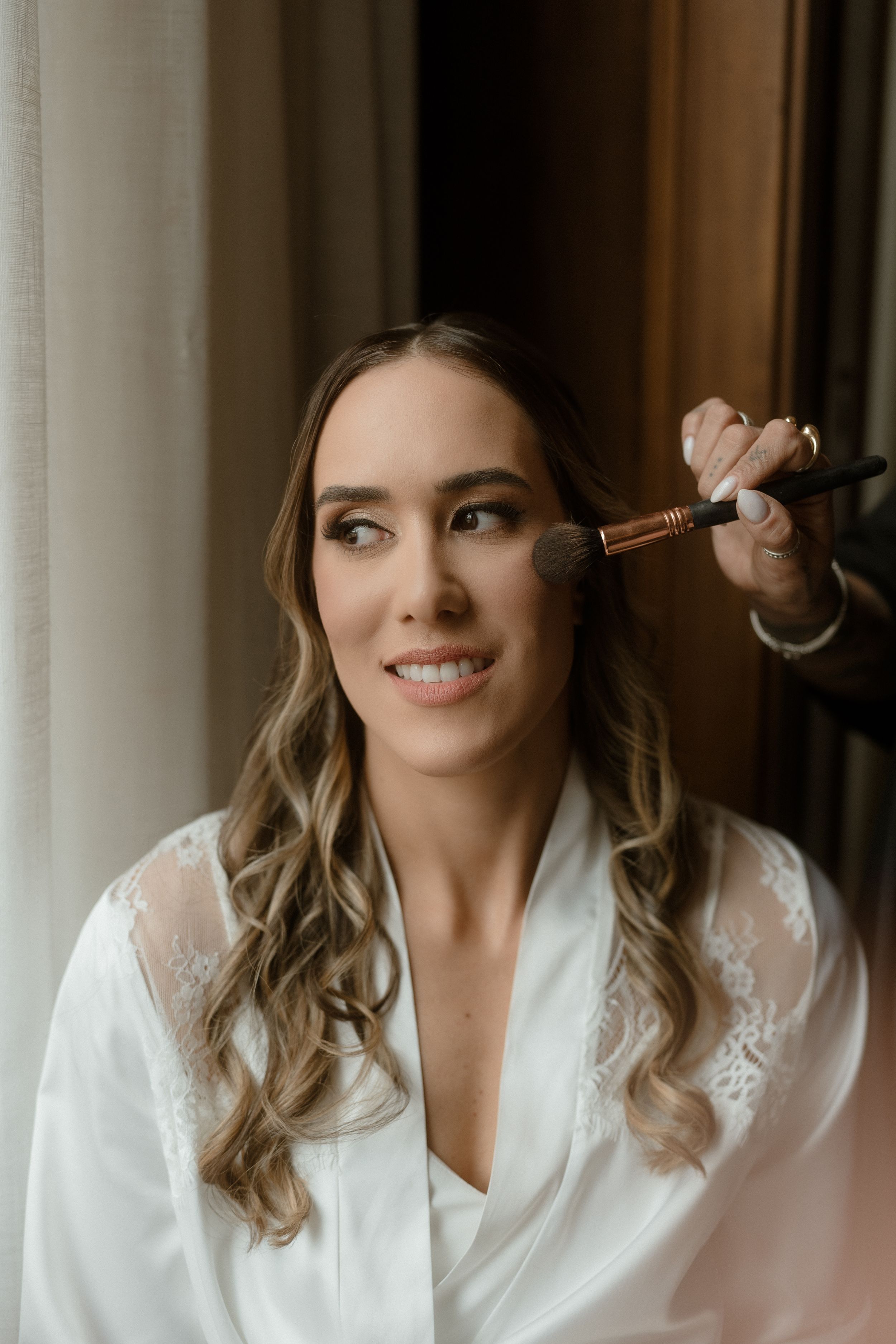 Makeup application close-up shots showing mascara and cosmetics being applied.