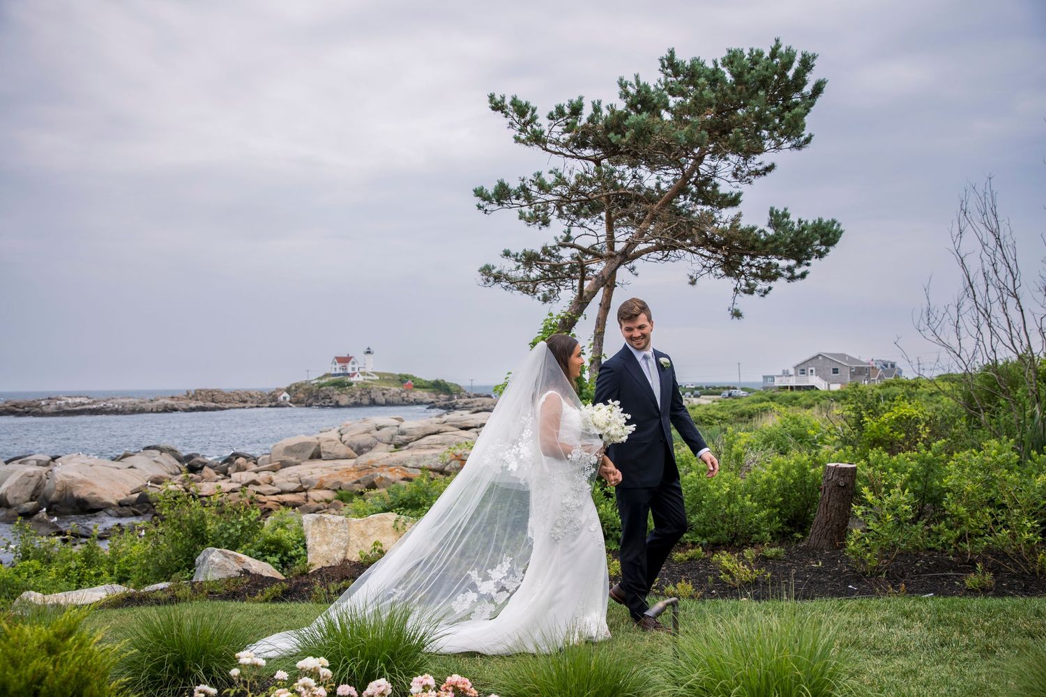 Wedding photos captured on rocky coastal cliffs with scenic ocean views.
