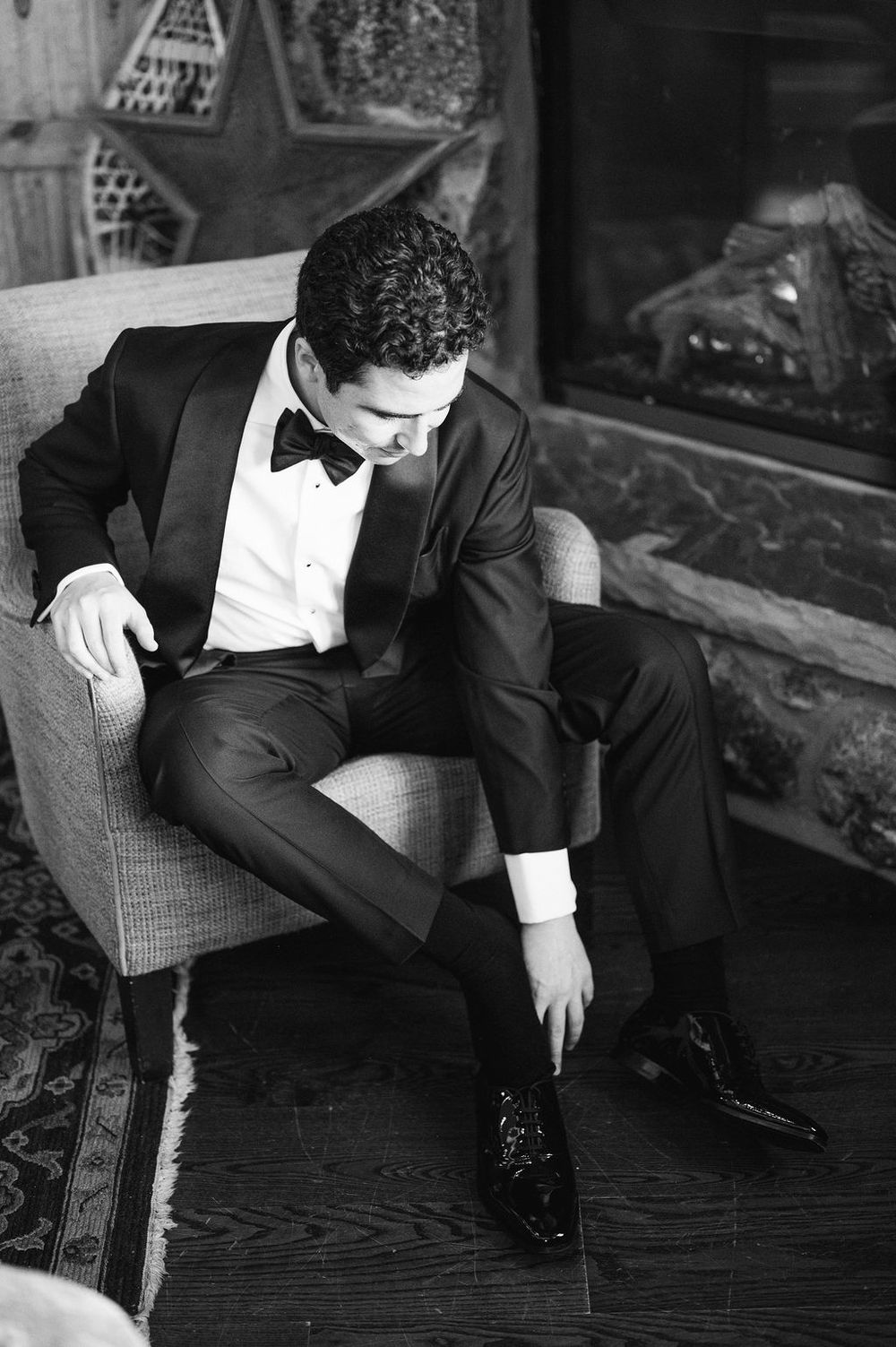 Black and white photo series showing a person in formal attire reclining on a chair in various artistic poses.