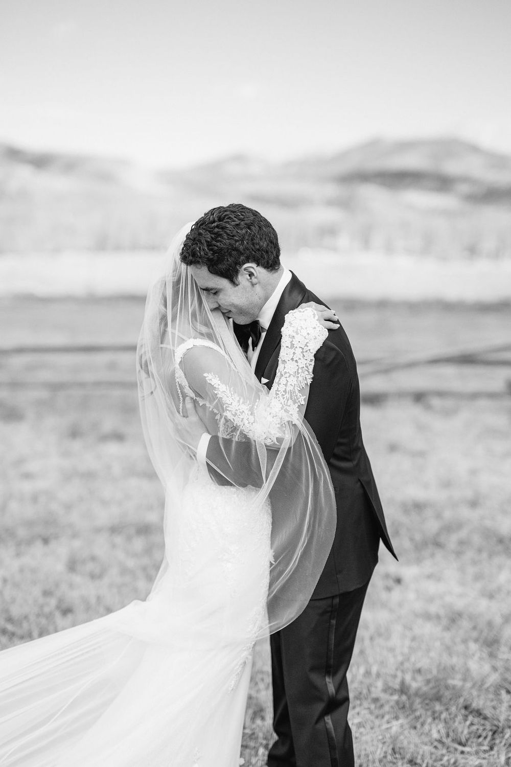 A romantic black and white wedding photo sequence shows a couple embracing in a windswept field.