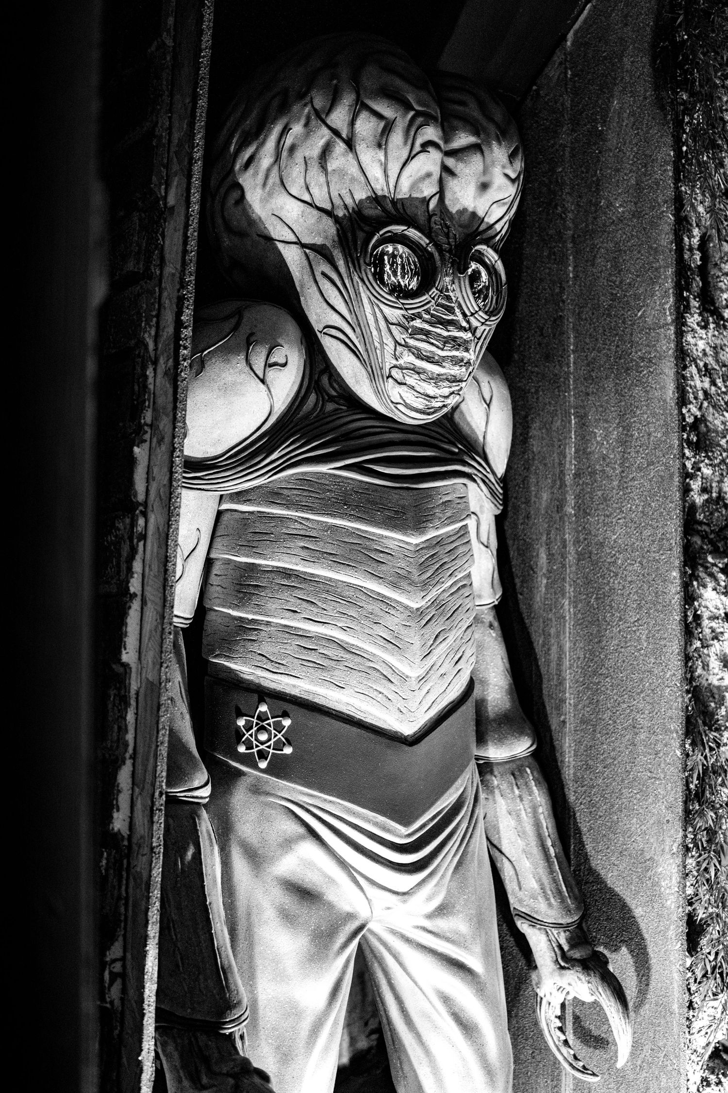Black and white photo of an alien mannequin figure in theatrical costume.