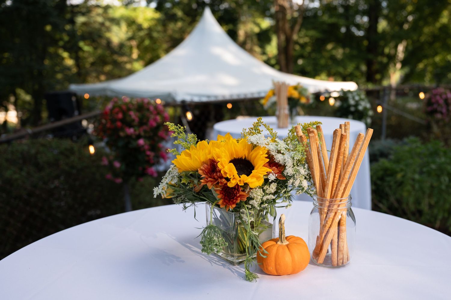 Beautiful sunflower centerpiece at a surprise wedding in New Jersey, with rustic accents and warm lighting. Book your event photographer