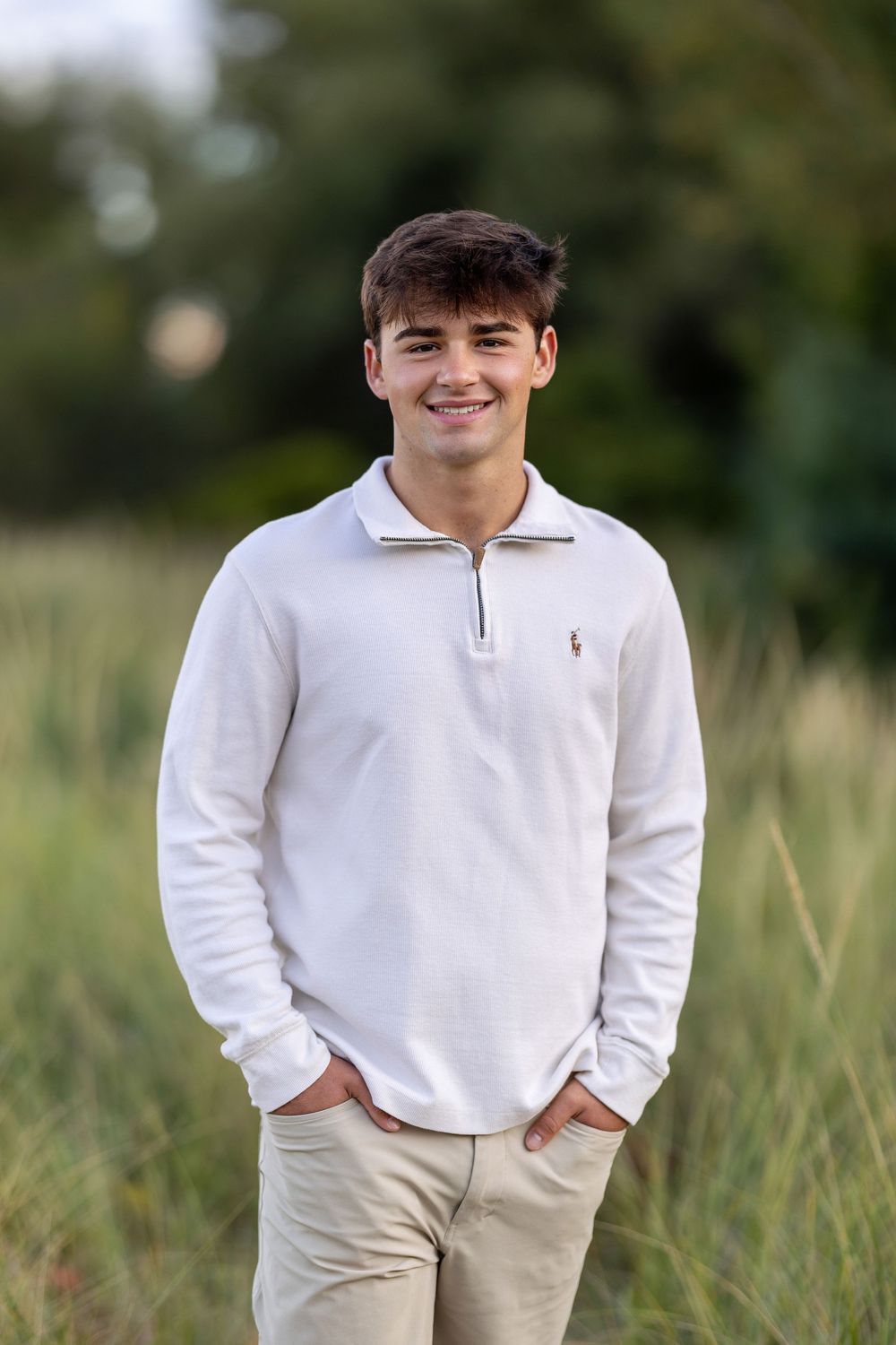 High school senior portrait at sunset in a field at New Castle, NH