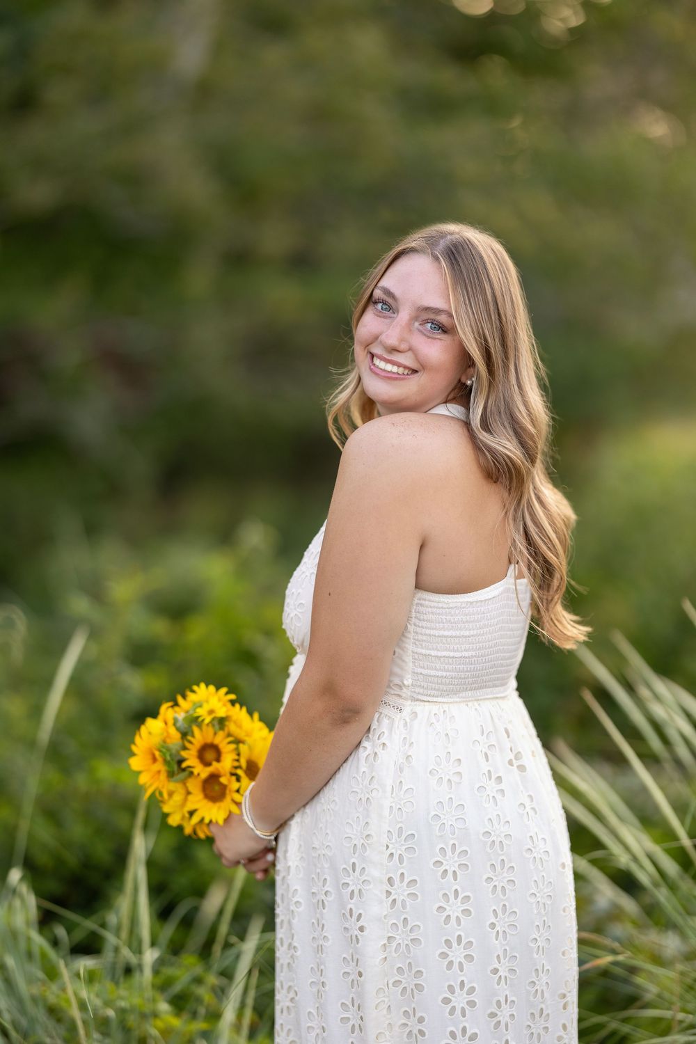High school senior portrait with flowers in New Castle, NH