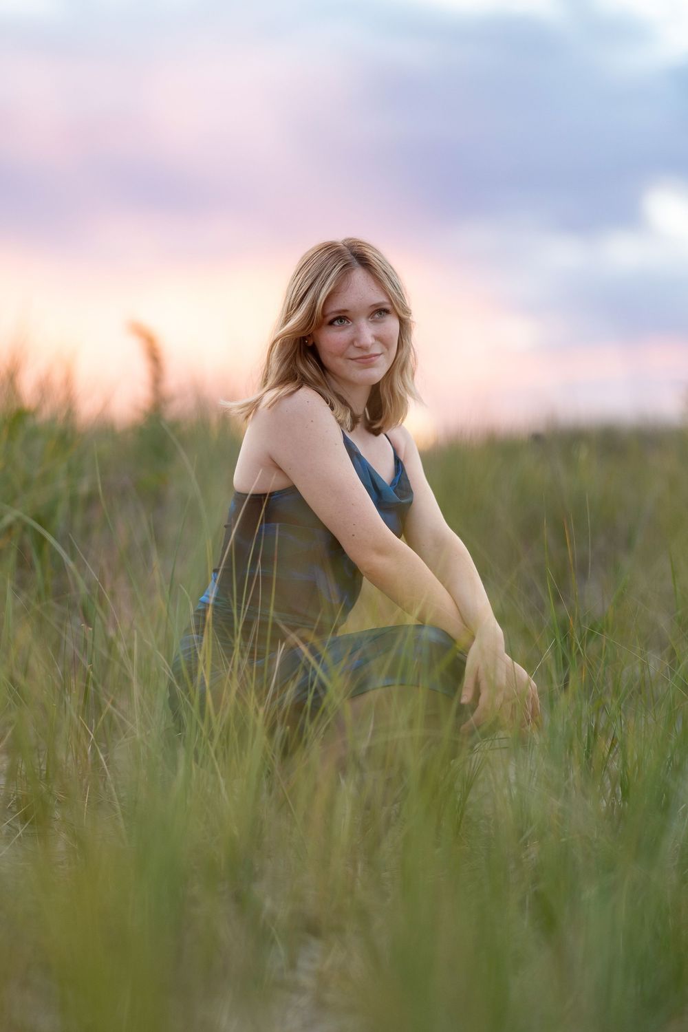 High school senior portrait at sunset in the sea grass at Hampton Beach NH