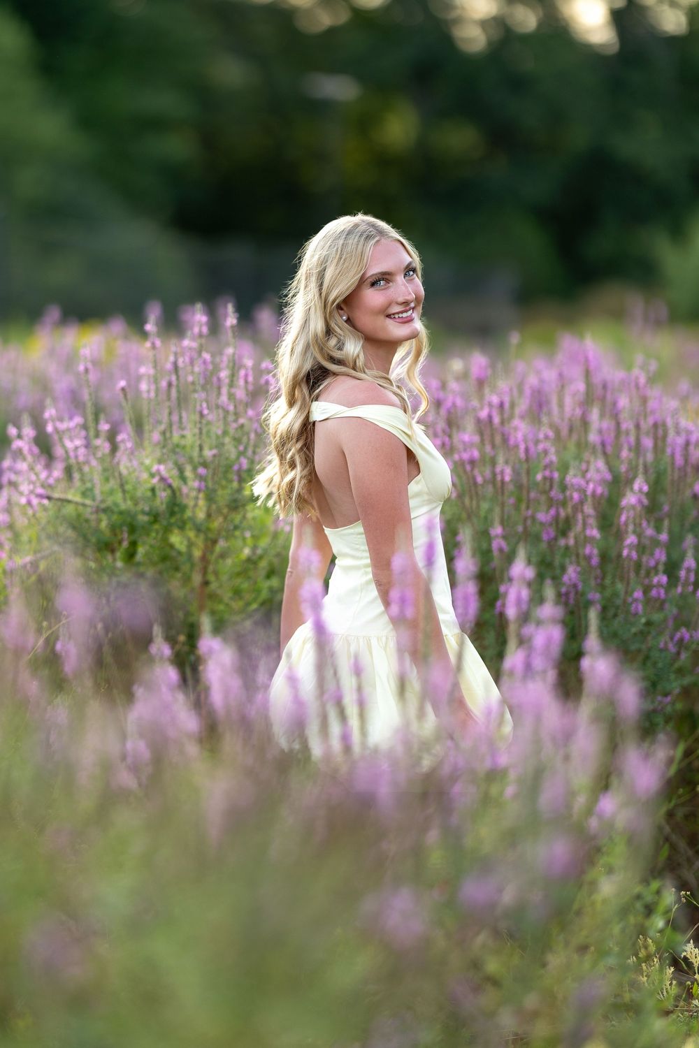 High school senior portrait at sunset in a wild flower field in Durham, NH