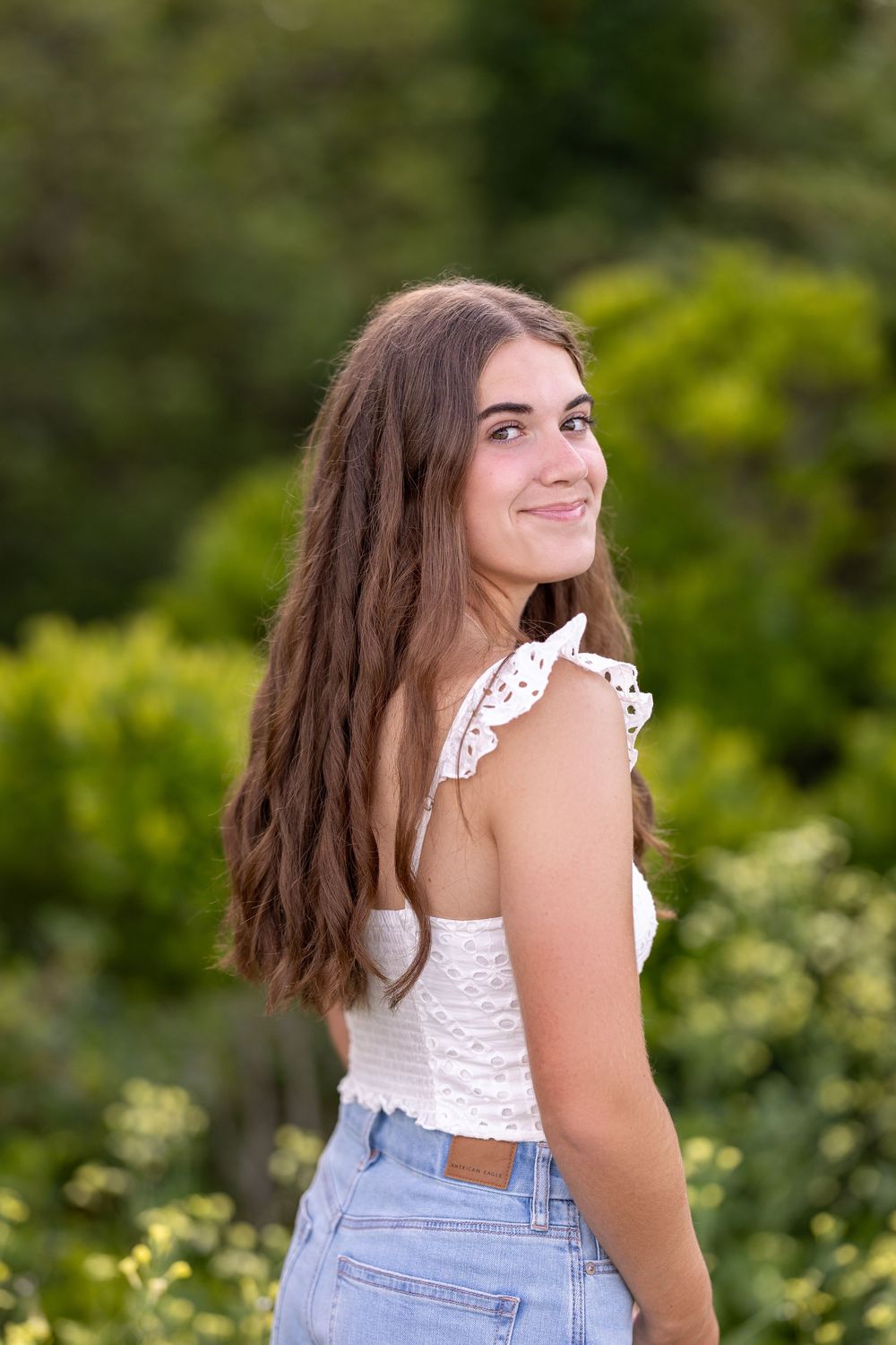High school senior portrait in a wild flower field in New Castle, NH