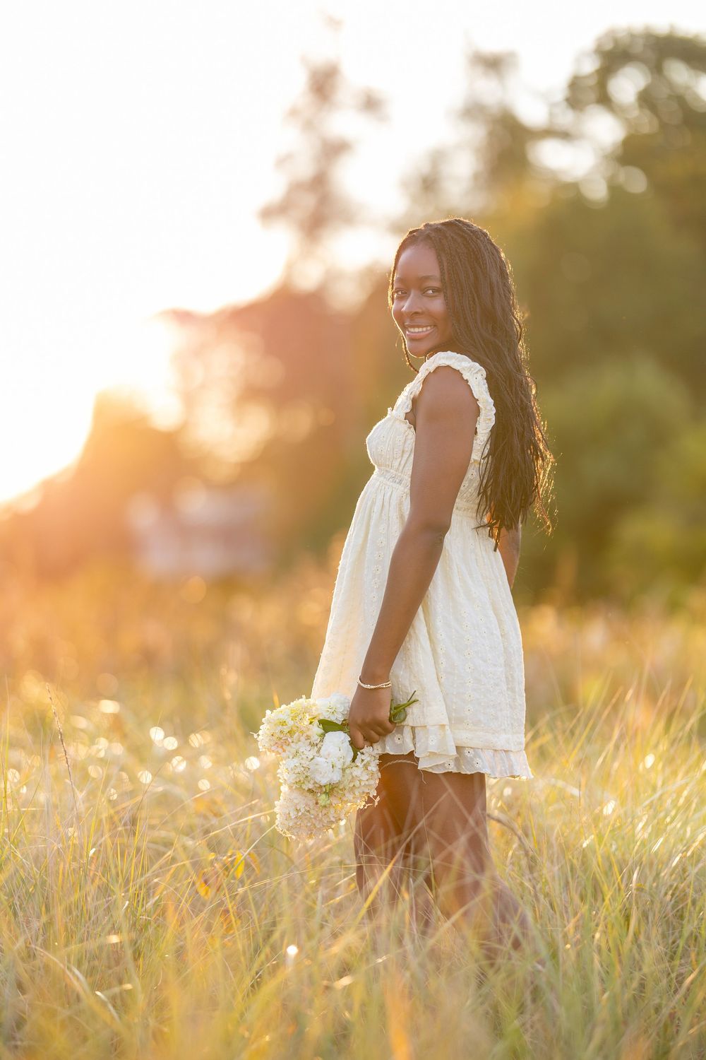 High school senior portrait at sunset in a field at New Castle, NH