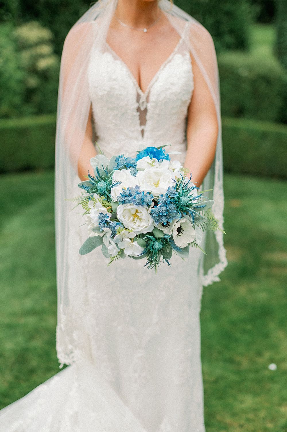 Beautiful blue and white bridal bouquet with eucalyptus and floral details.