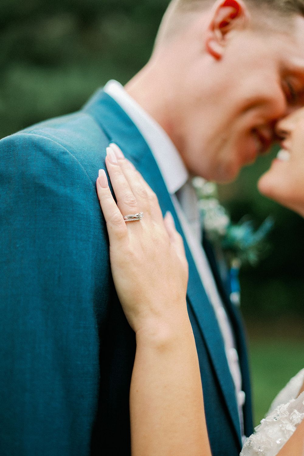 Intimate wedding couple moment captured in a romantic garden setting.
