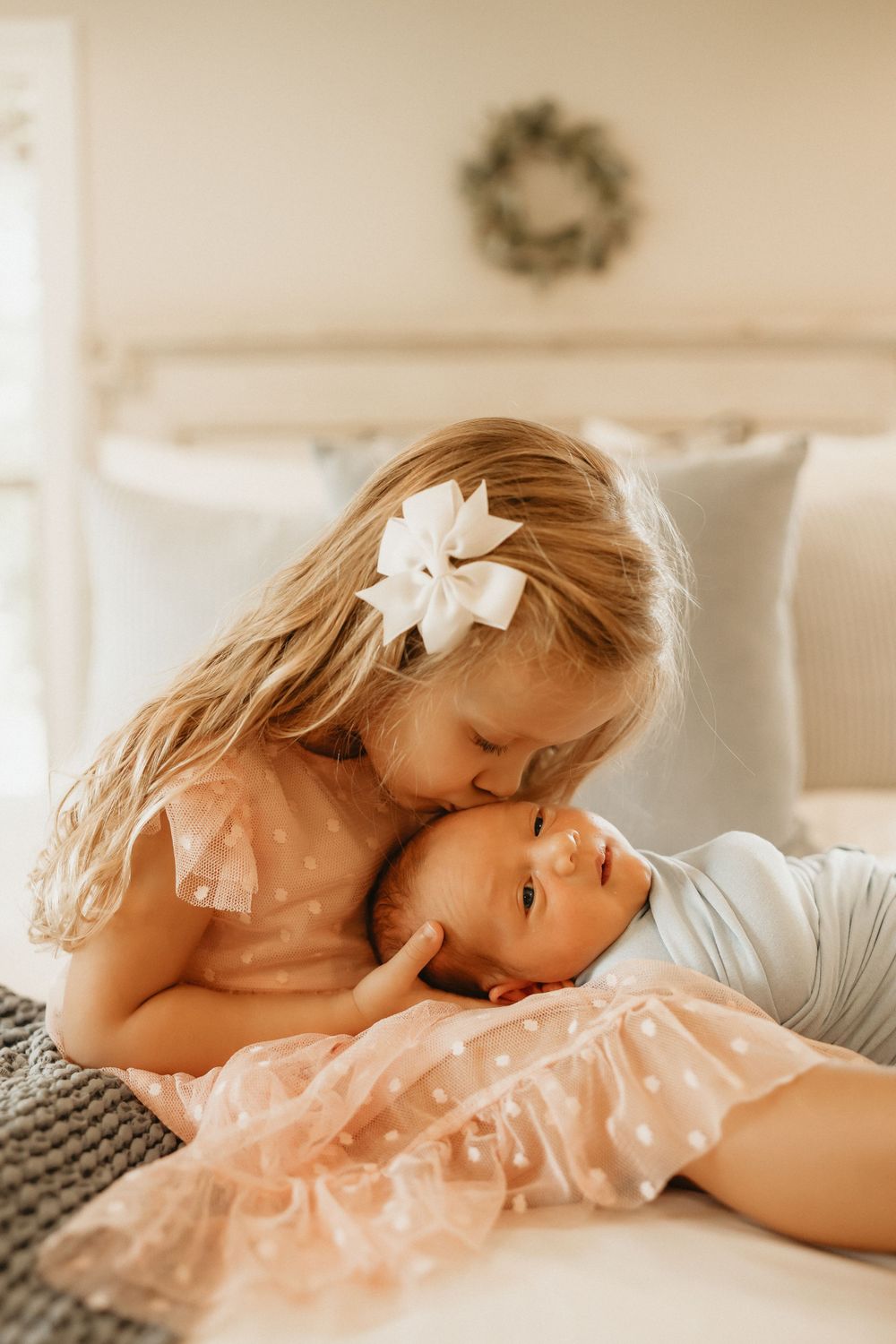 Adorable newborn portrait of a baby with closed eyes, peacefully cradled in a photographer's hands.