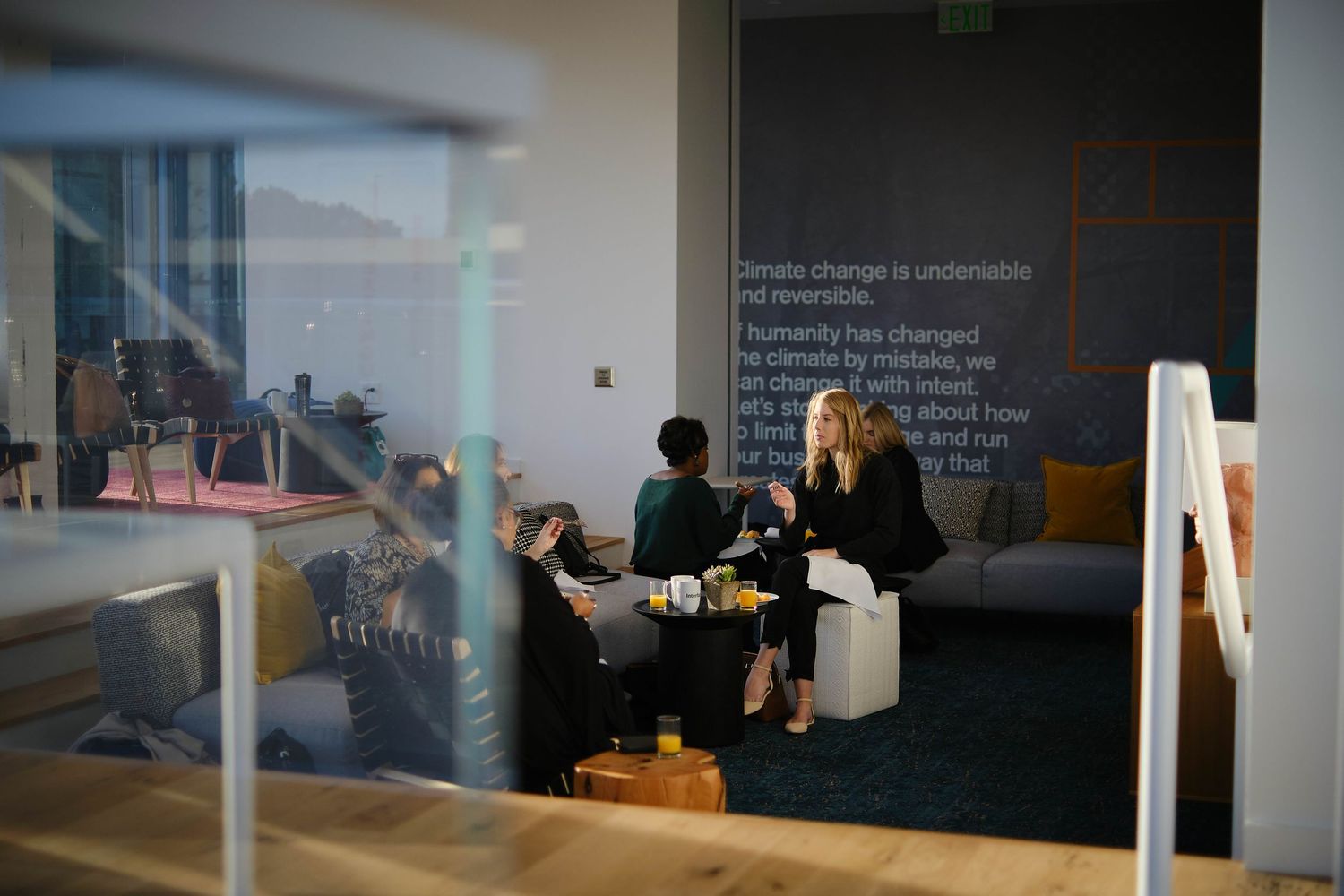 Modern office meeting space with text projections on dark walls.