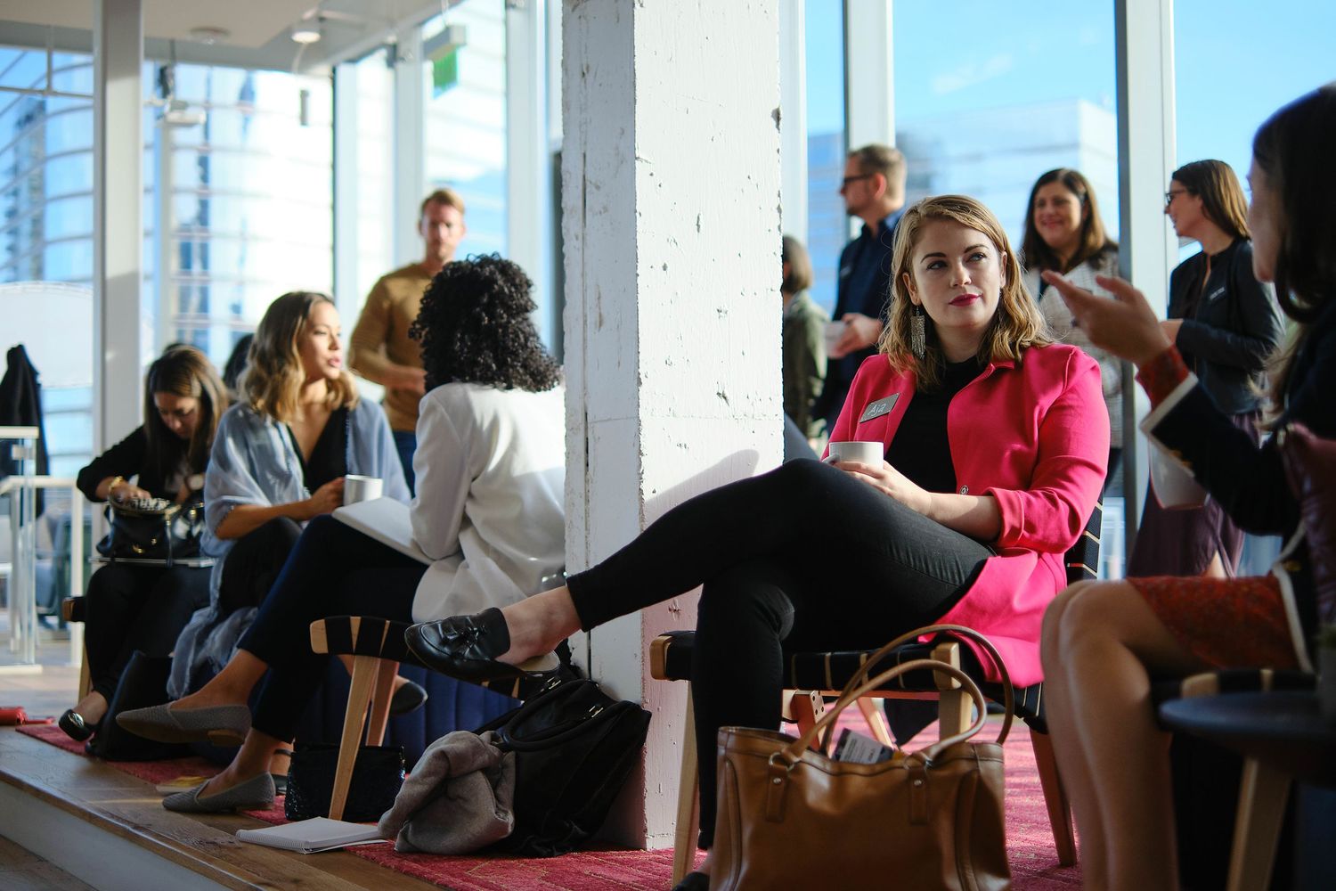 Casual meeting area with people gathered in modern office space.
