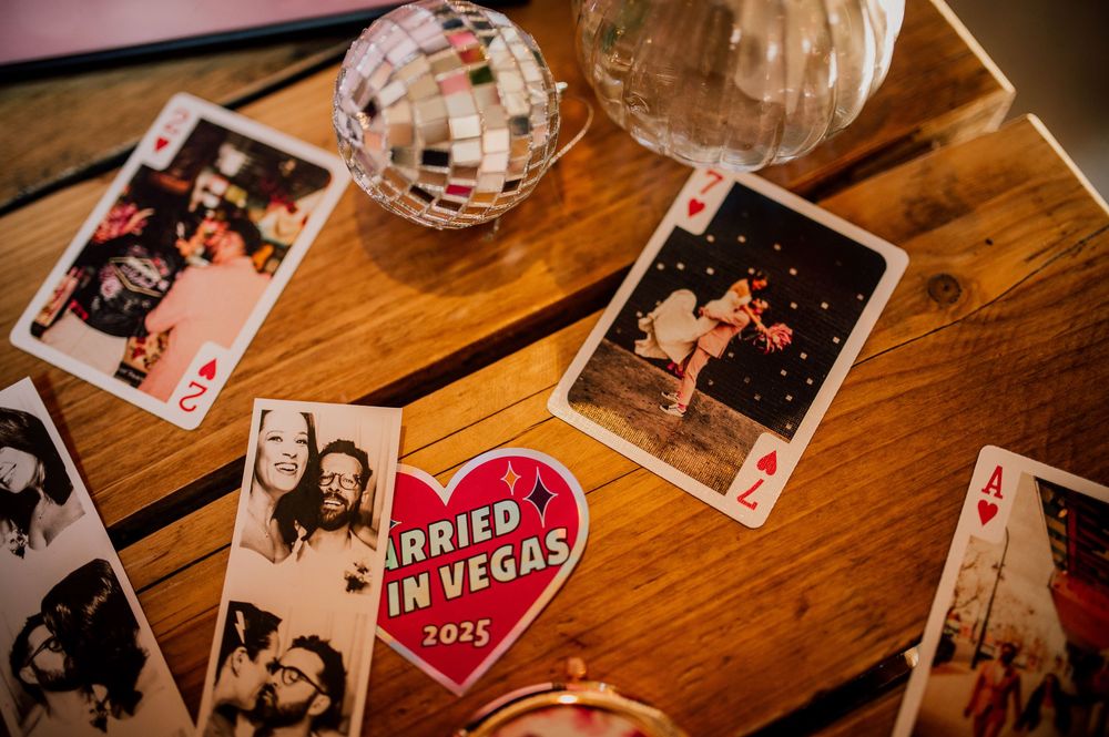 A wooden table displays wedding photos and a disco ball, creating a nostalgic wedding memory display setup.