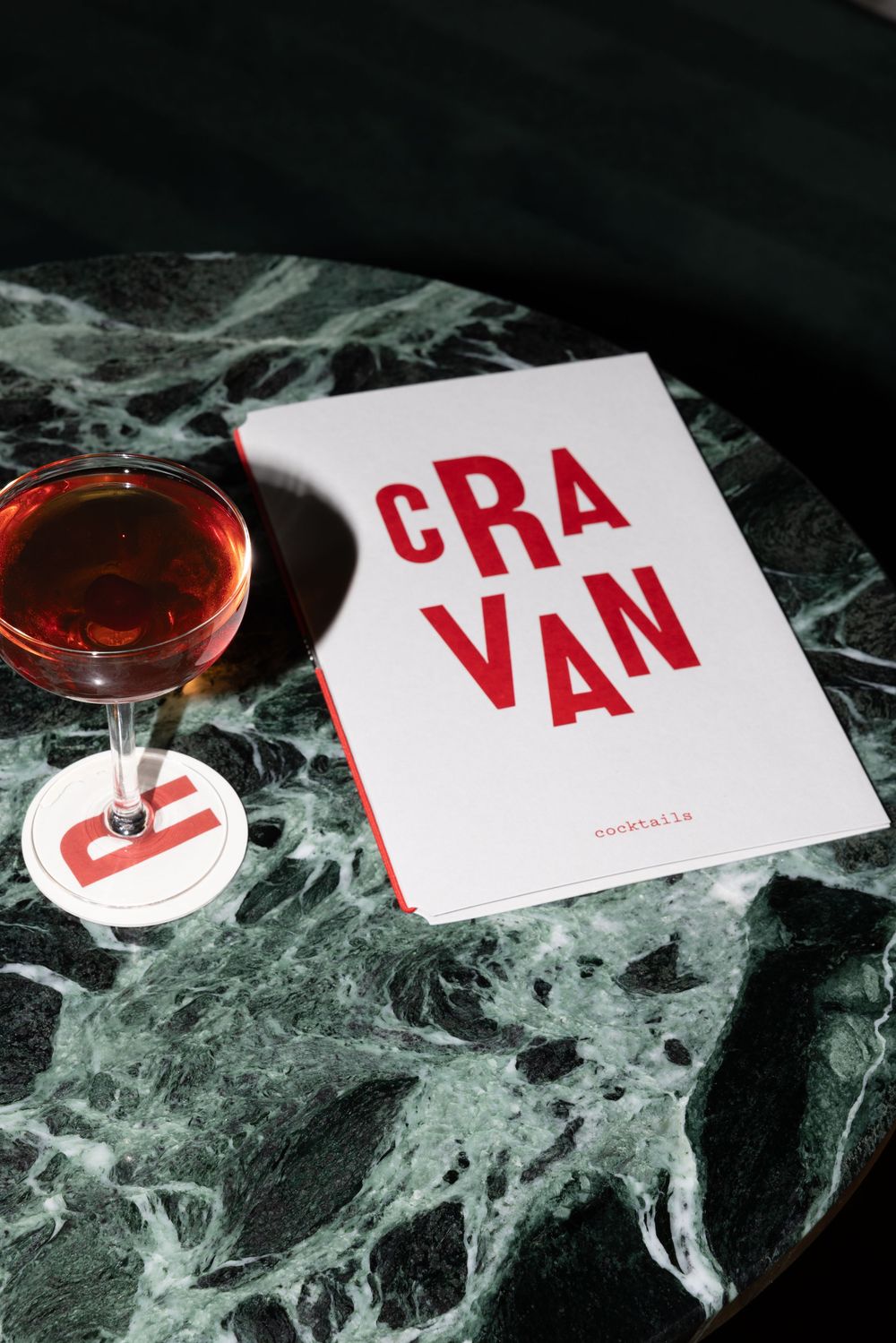 A series of white cards with red text spelling 'VAN' arranged among spooky cobweb decorations and reddish lighting effects.