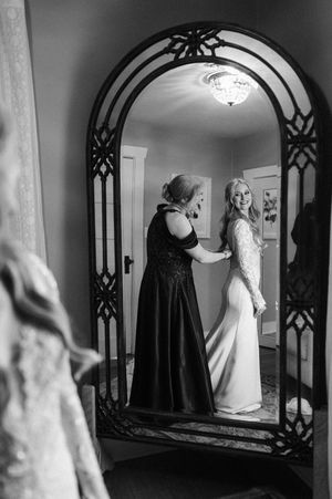 Black and white photos show two figures in gothic archways creating a dramatic mirror-like sequence of images.