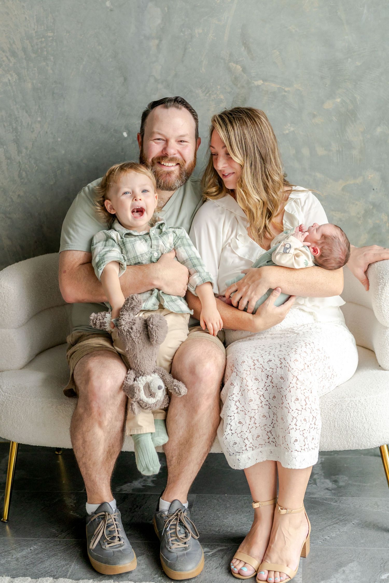 A family shares candid moments on a couch, showing playful interactions and laughter in a series of lifestyle photos.