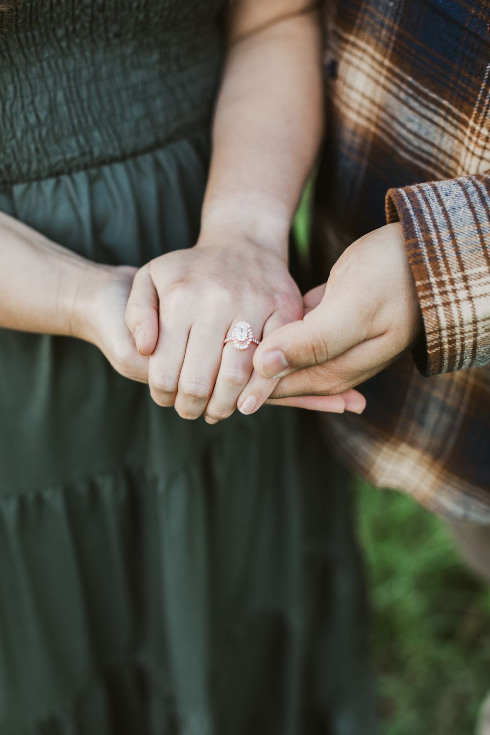 Man holds fiancee's hand to display engagement ring in Concord. Middlesex County, Berkshires, Central MA engagement couple photographer.