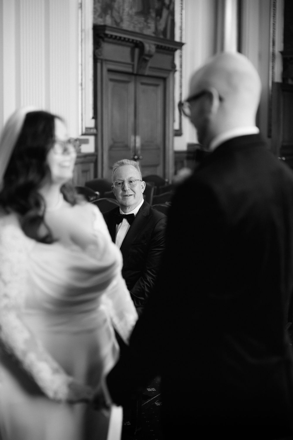 A series of four black and white photos showing blurred motion and movement in what appears to be an indoor setting.