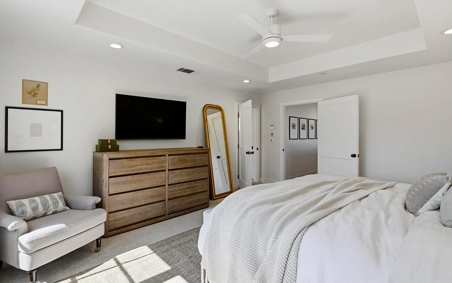 Modern open concept home interior with light hardwood floors and recessed lighting showcases seamless design flow.