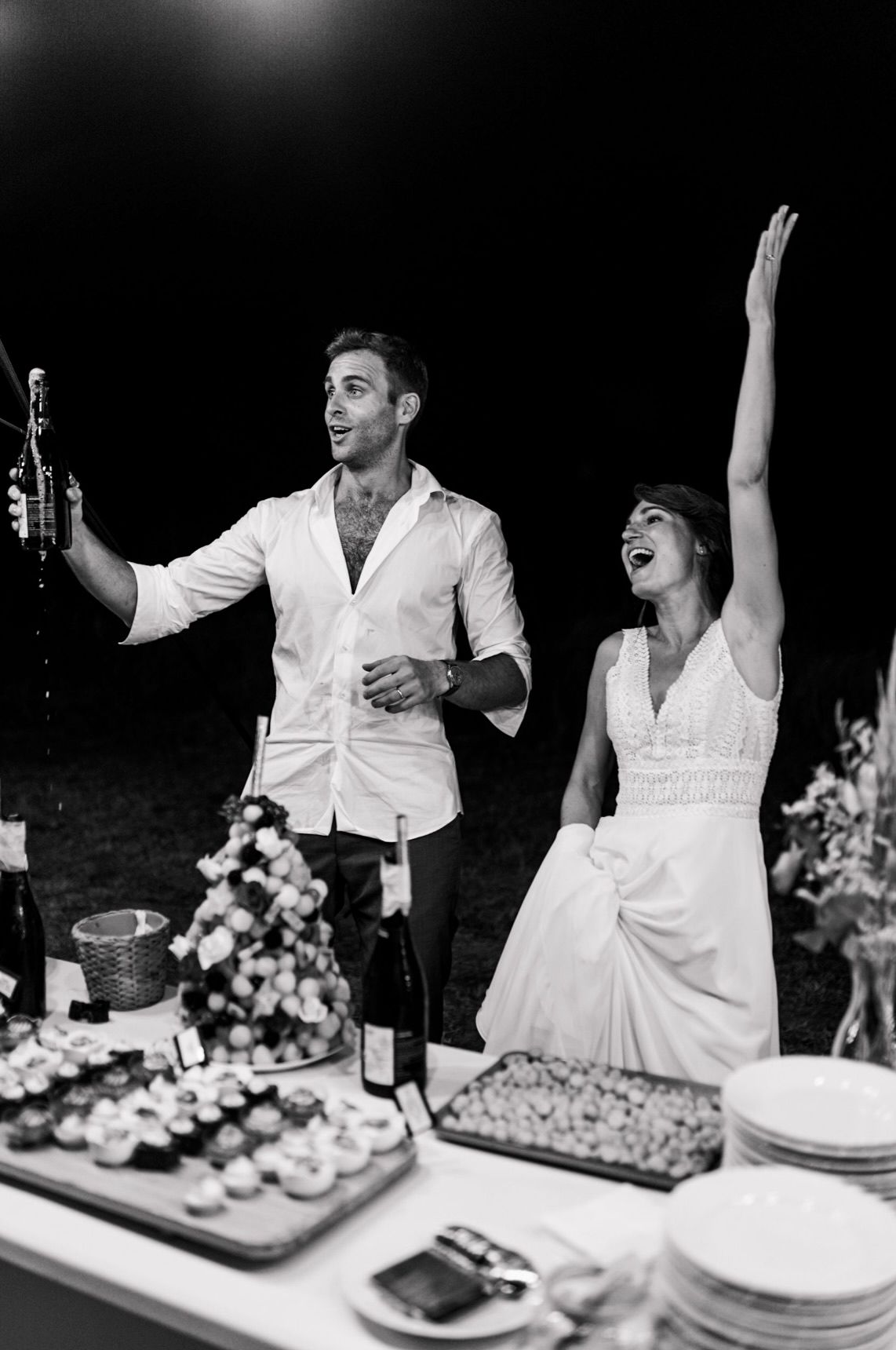 Black and white candid wedding reception photos showing joyful moments between couple during toasts and celebrations.