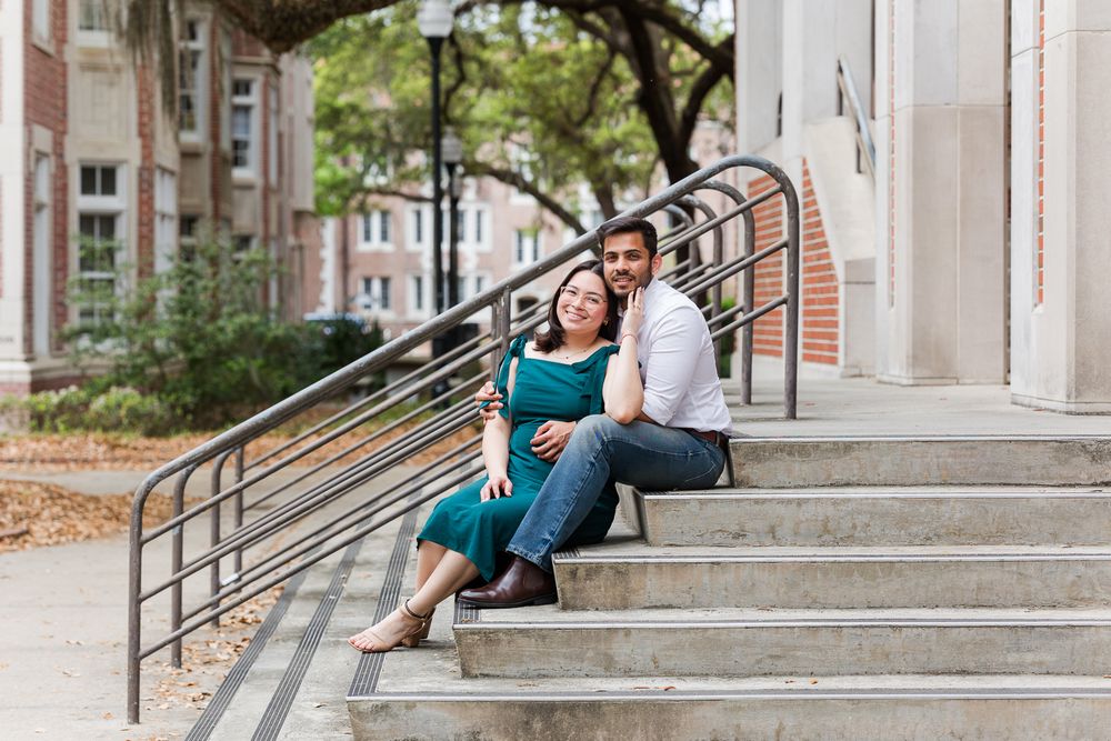 College students sitting and relaxing on outdoor campus steps during a sunny afternoon.