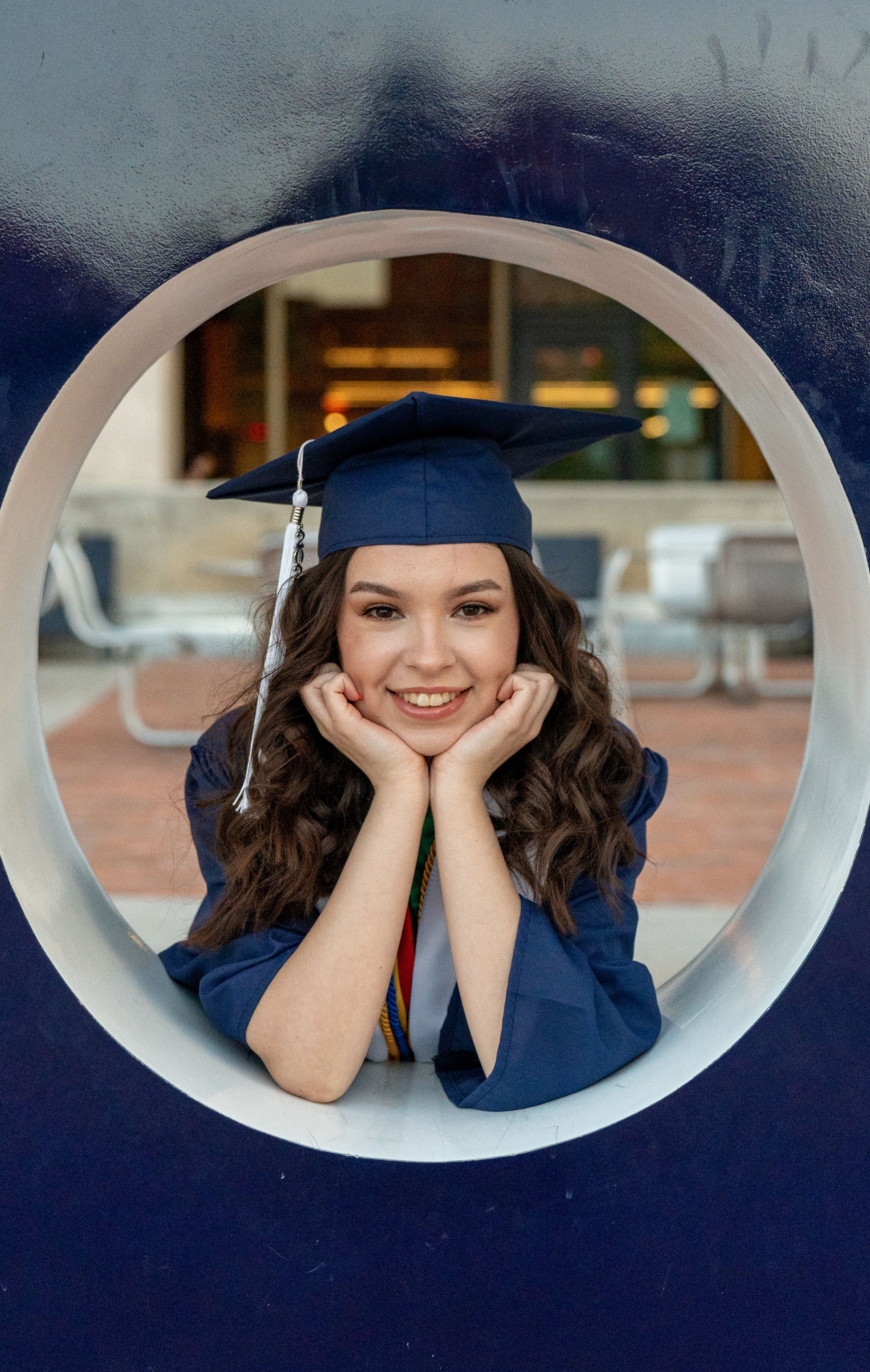 UofA senior framed inside the iconic Bear Down sign during a campus graduation shoot in Tucson, by N&D Media Production.