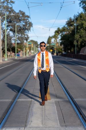 Graduation portrait of an engineering student gazing into the golden hour sun on 2nd Street at UofA, by N&D Media Production.