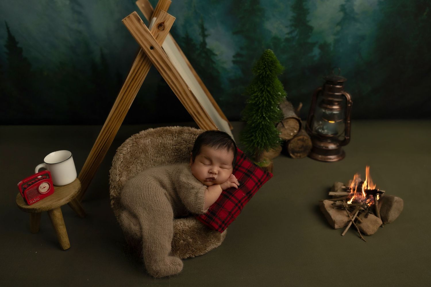 A cozy winter scene with a glowing campfire, plaid blanket, and warm coffee mug in the forest at dusk.