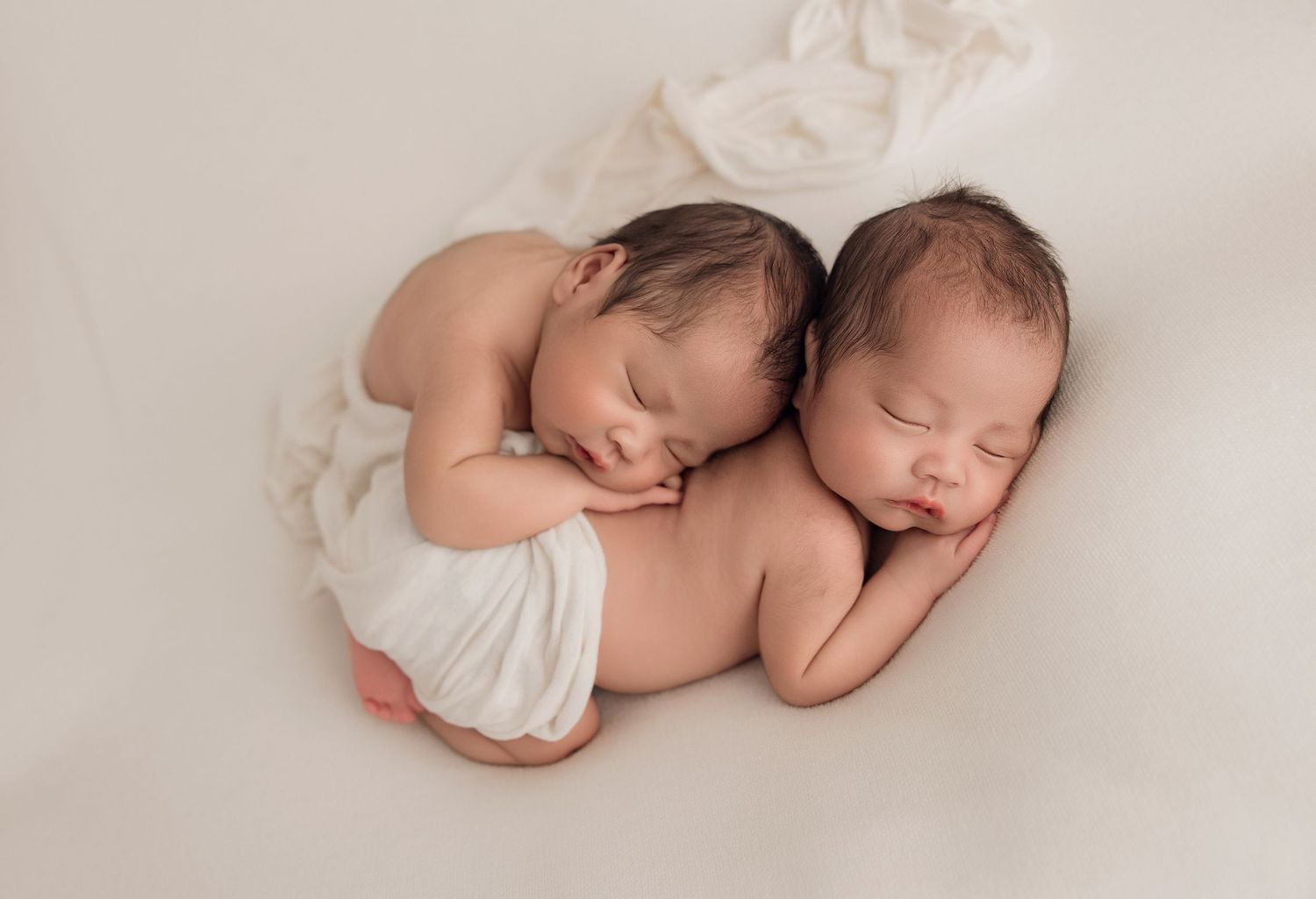 A series of soft, minimalist newborn baby photographs showing peaceful sleeping poses in neutral tones.