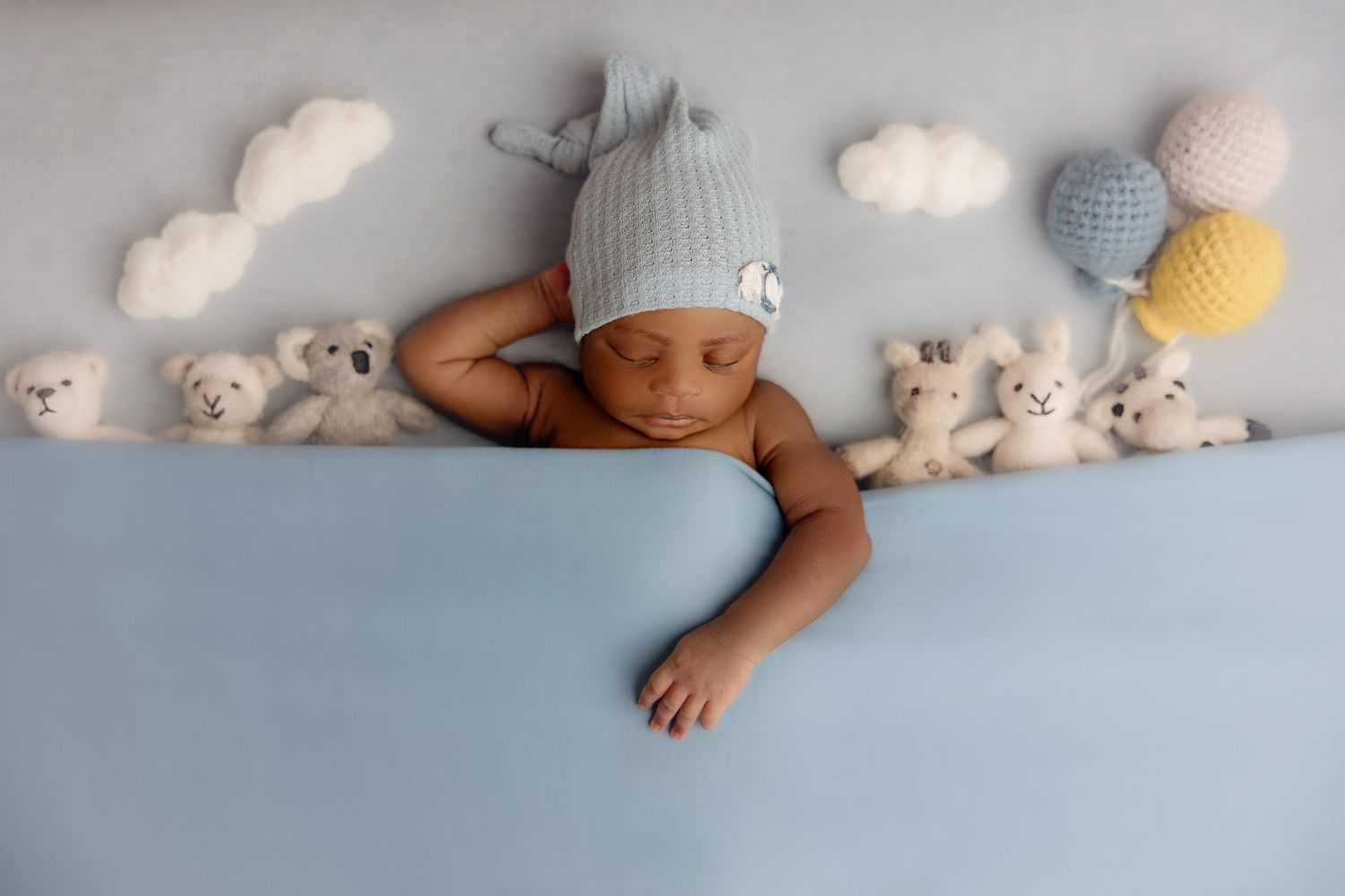 A series of six connected images showing a sleeping baby with stuffed animals and plush toys on a white backdrop.
