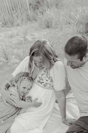 Black and white intimate family moments captured in a series of tender embraces outdoors.