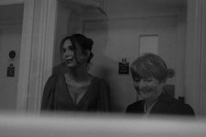 A black and white photo strip showing a sequence of playful poses and interactions between two people.