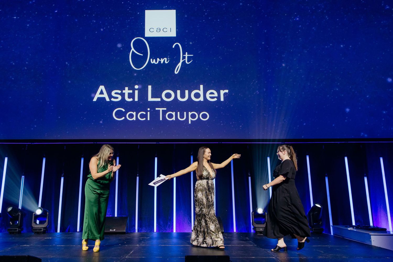 Presenters on stage giving an award to a winner at a corporate event