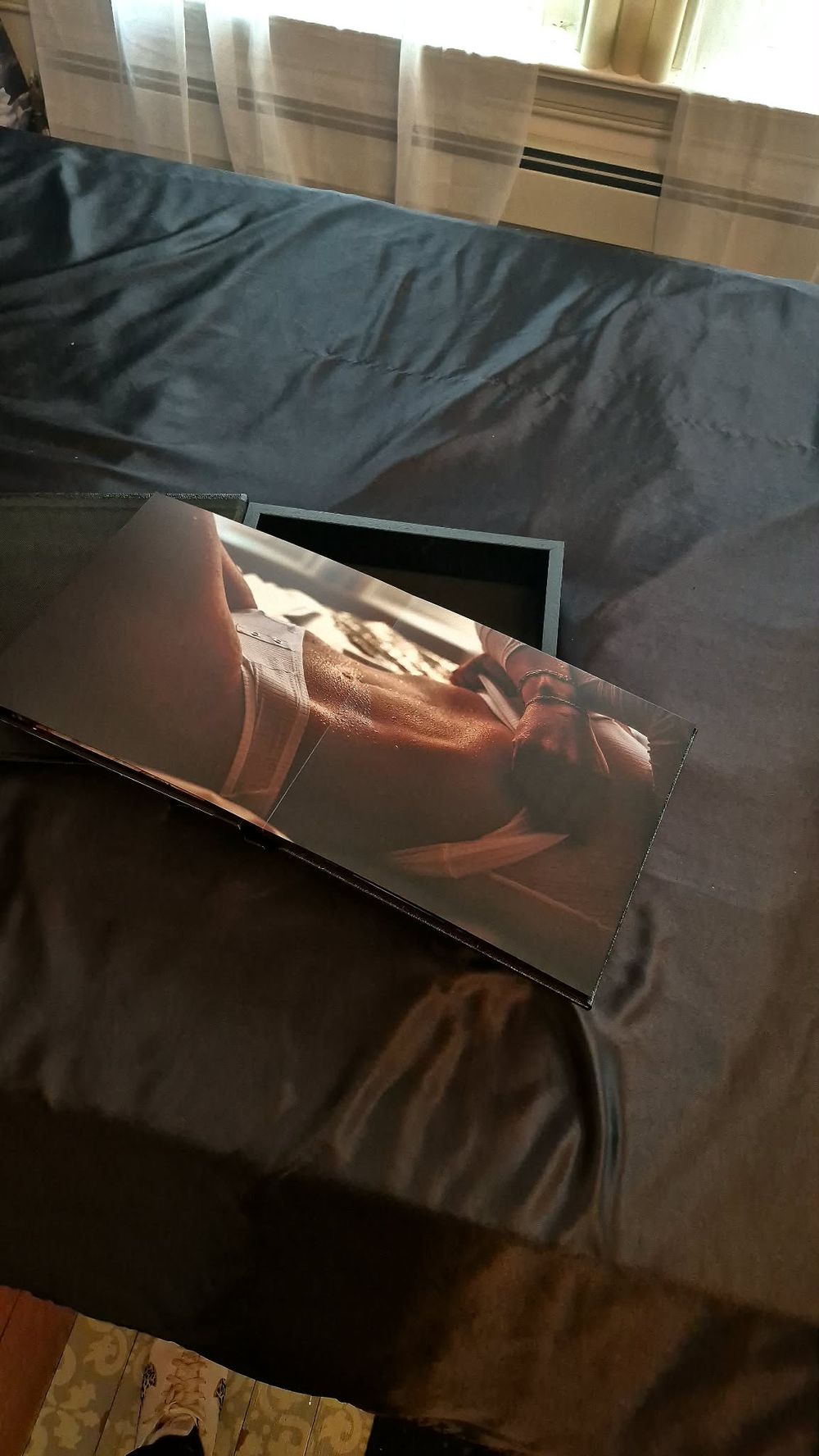 A sequence of photos showing a laptop screen being closed in progressive stages against a dark background.
