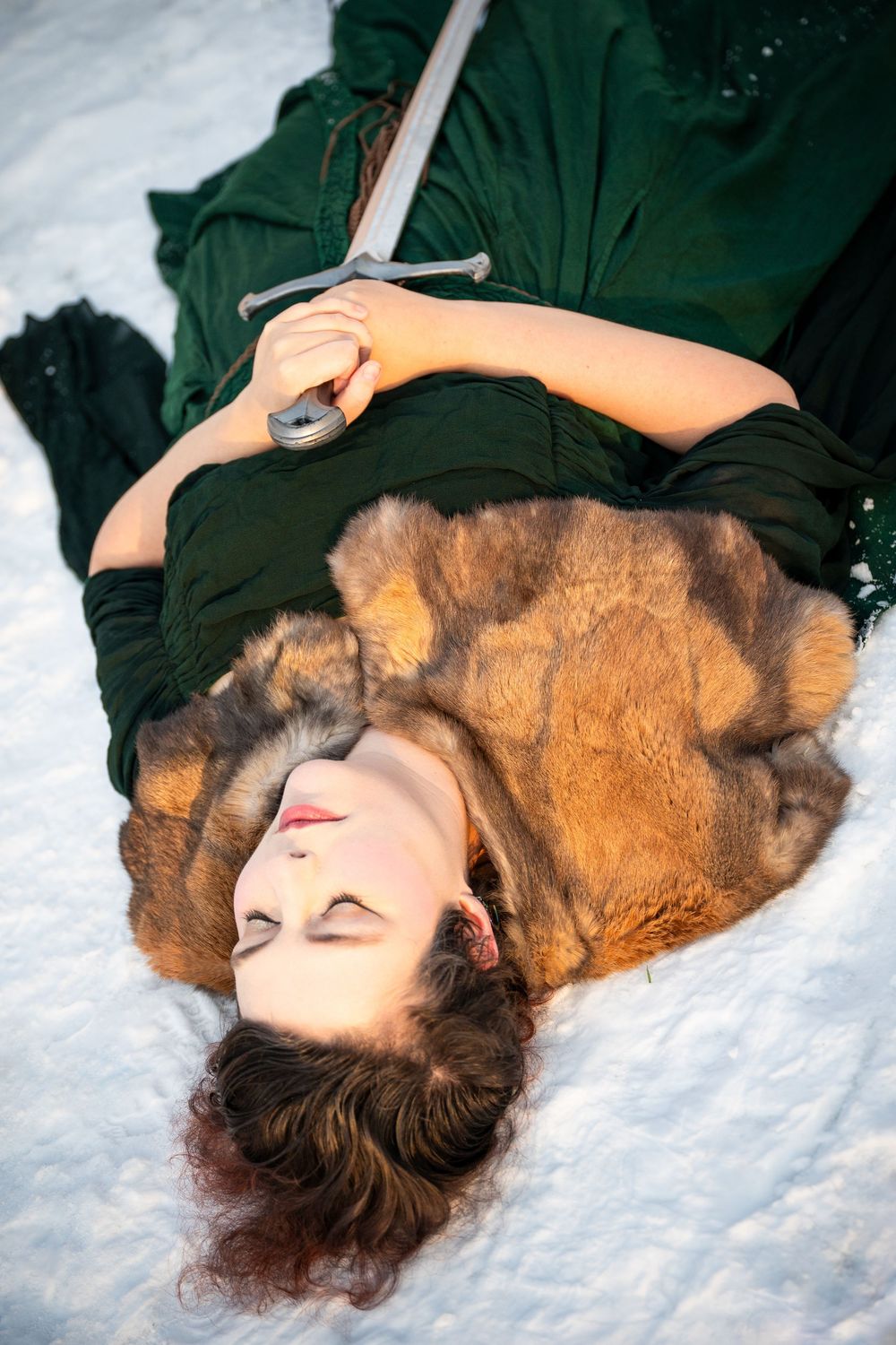 portrait of a person with a sword in the snow