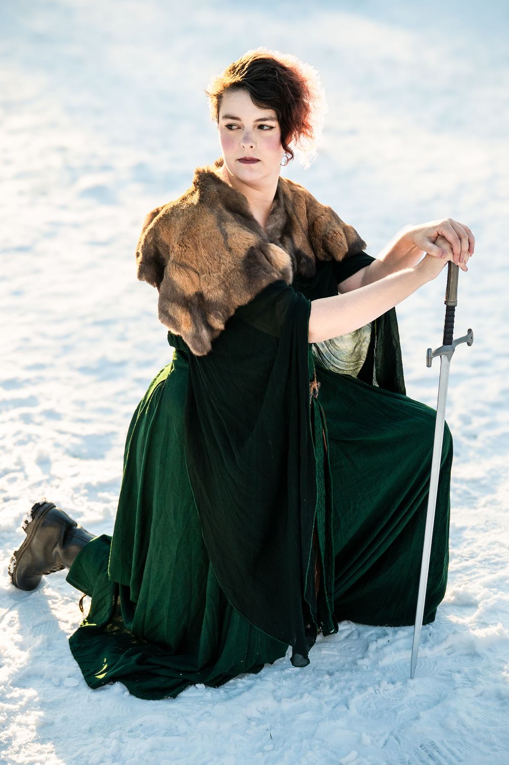 Portrait of person with sword in snow