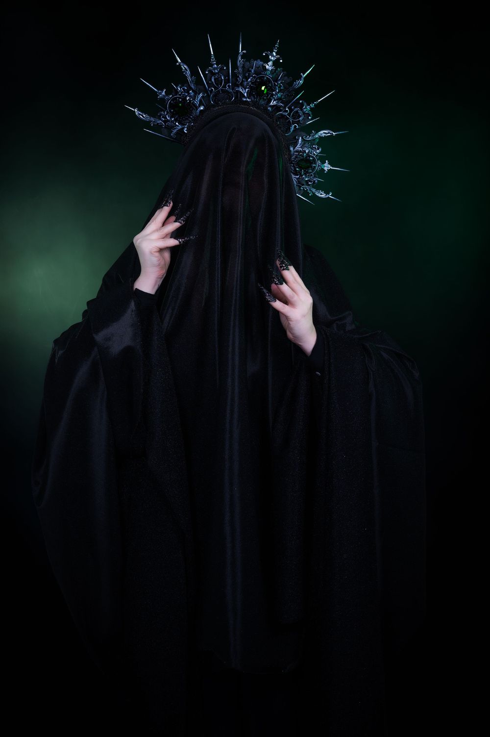 Portrait of person cloaked with crown