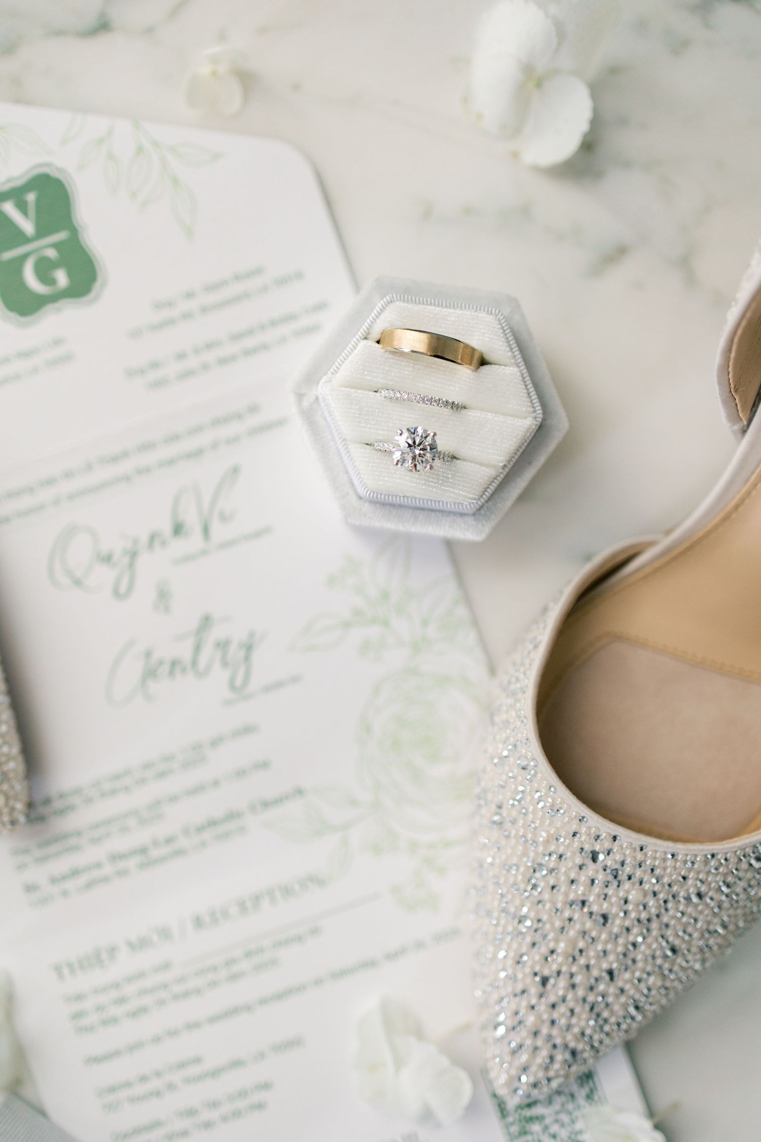 Flat lay details of invitation suite and bridal details.