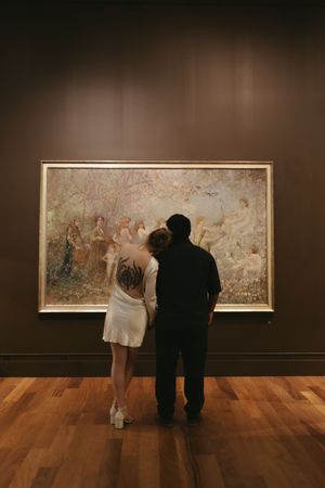 A couples engagement session in Florida museum admiring artwork with beautiful colors and light