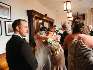 Wedding reception venue with elegant lighting fixtures and classic decor elements.