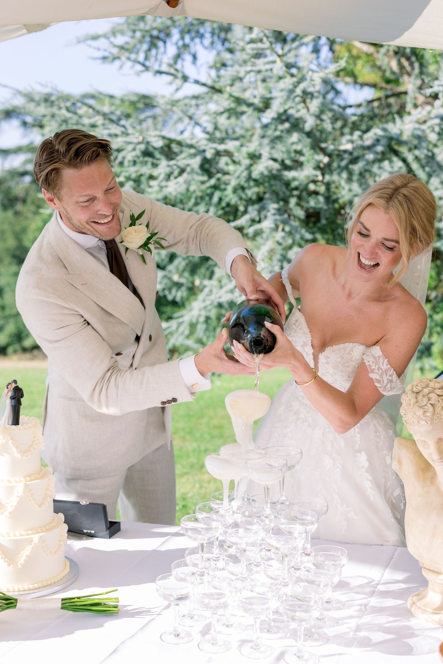Joyful couple laughing together during their outdoor wedding celebration.