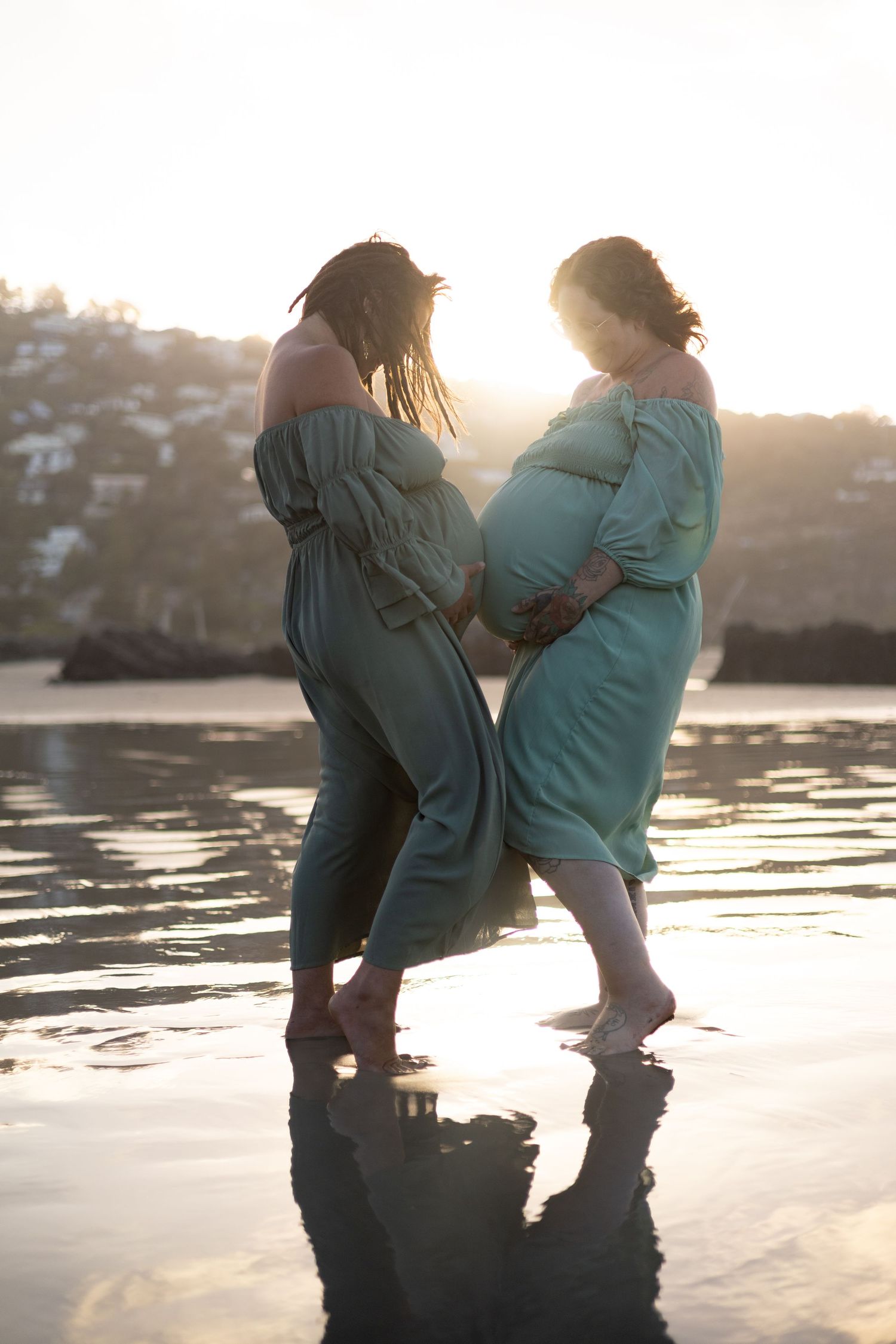 2 mums to be showing off their bumps during maternity session