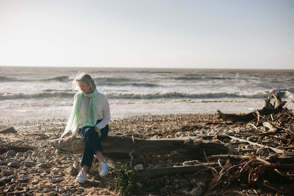 Life coach branding shoot - lady on the beach in charmouth Dorset on a windy day
