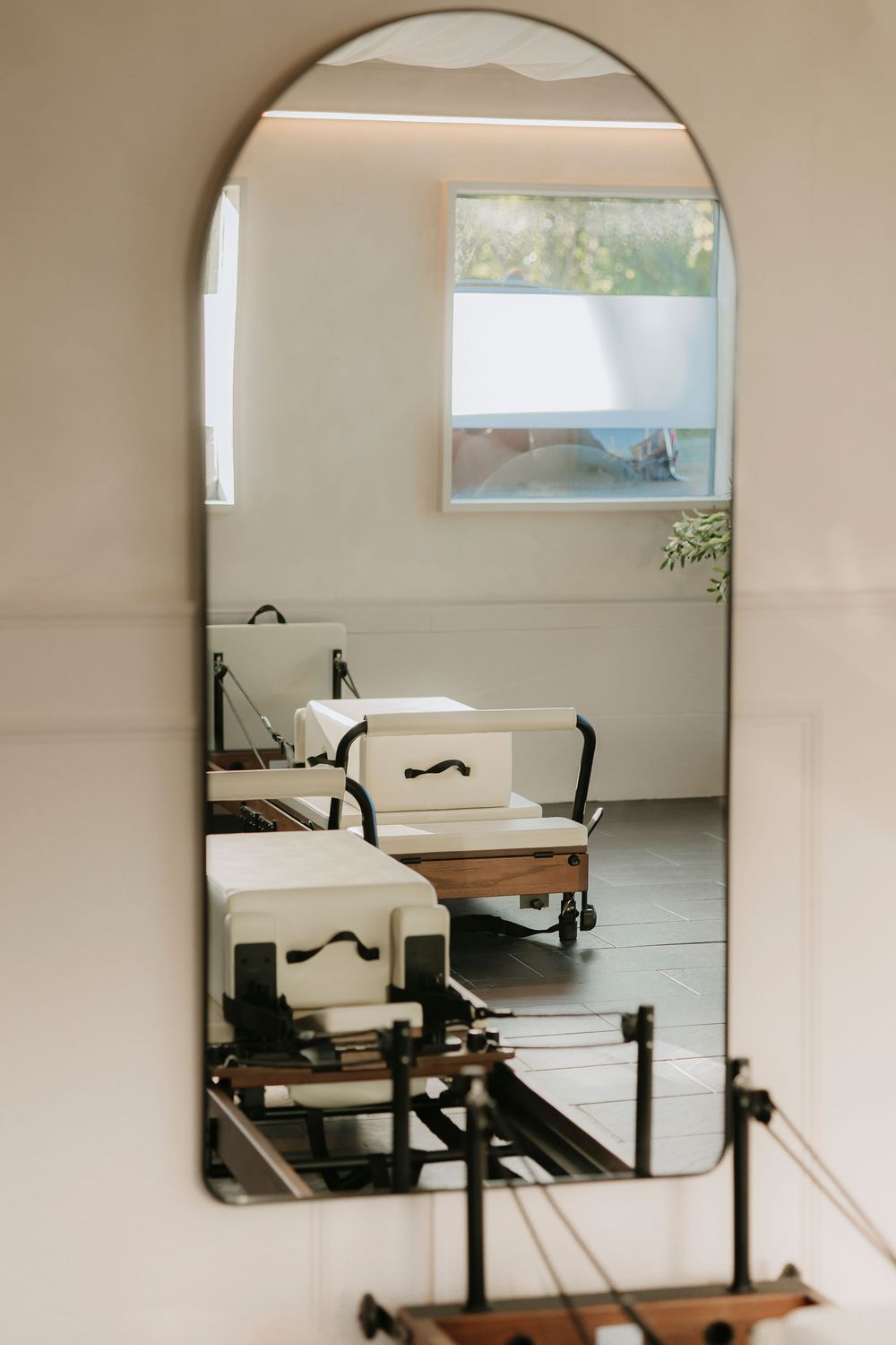 A room full of reformer pilates machines - The Pilates collective Rousdon