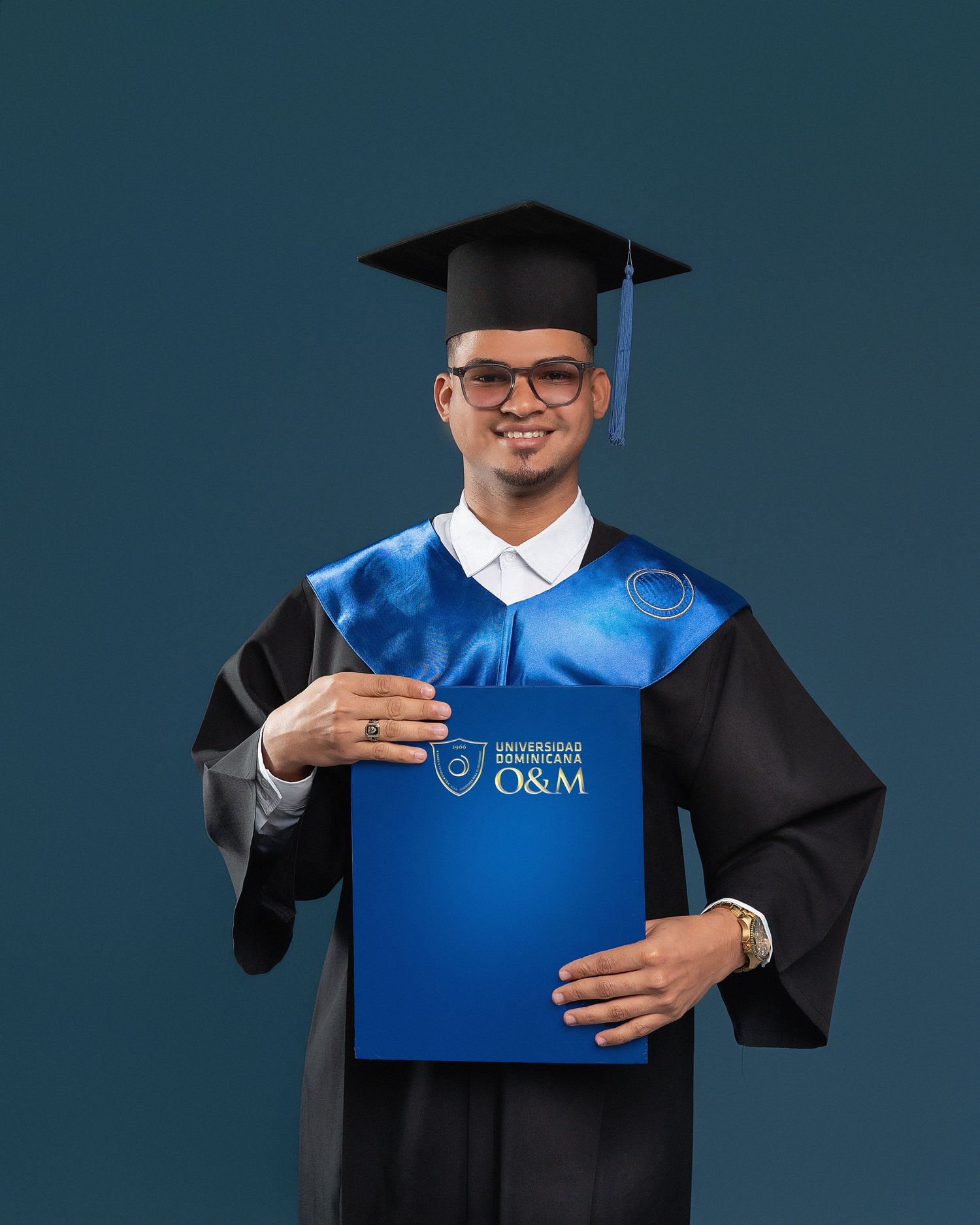 Graduate in red and black academic regalia poses with joyful expressions during graduation photo session.