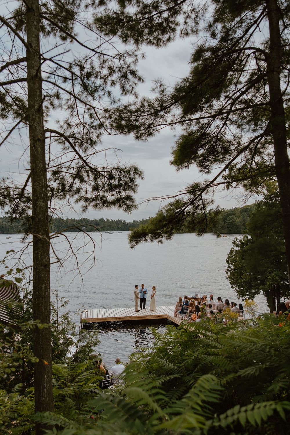Wedding ceremony on private dock in Muskoka. Howdy Pictures - film wedding & elopement photographers in Canada & New Zealand.