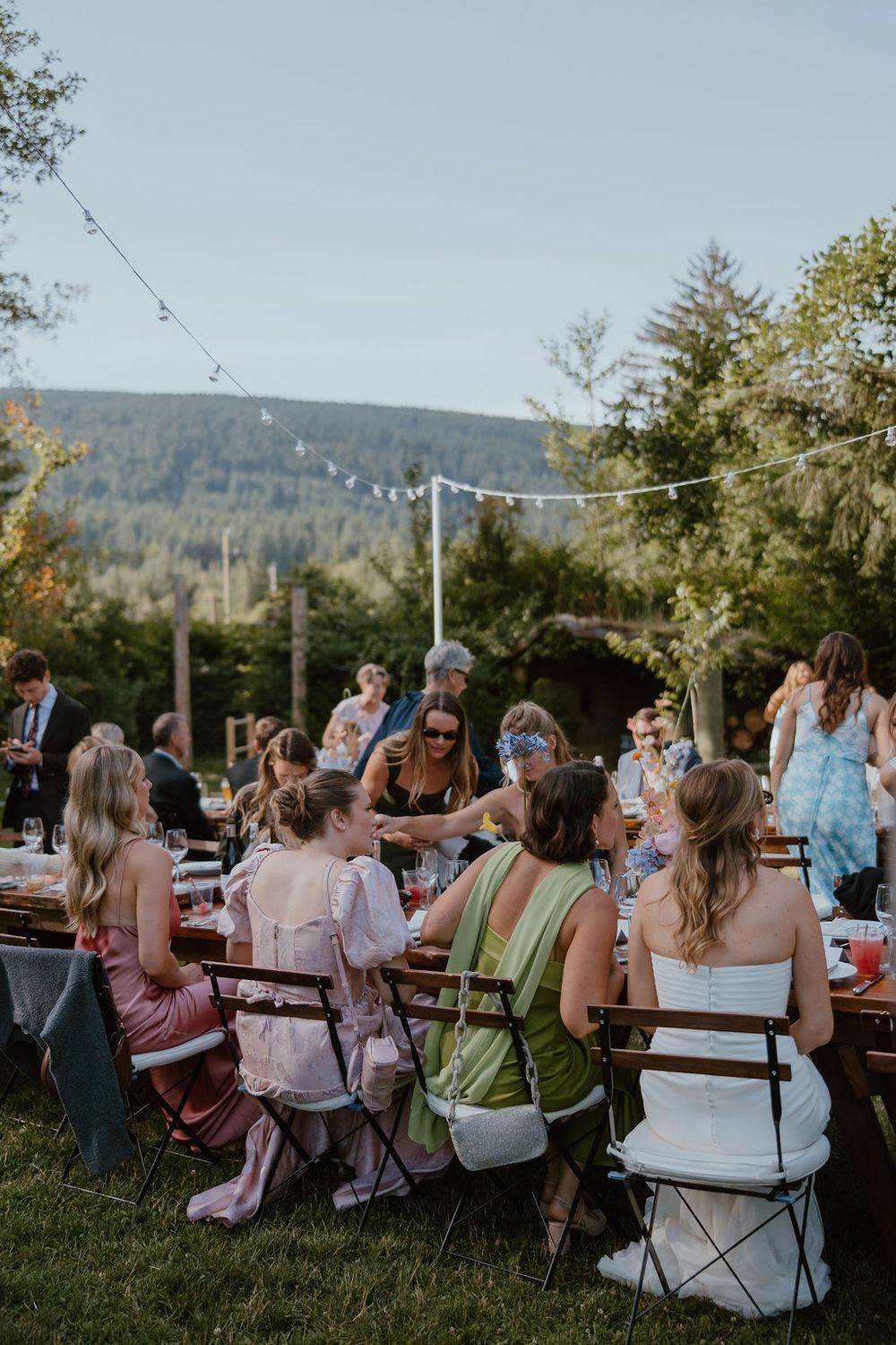 Colourful outdoor dinner al fresco, wedding reception at Gibsons Farm, BC. Howdy Pictures - film wedding photographers in Canada & NZ.