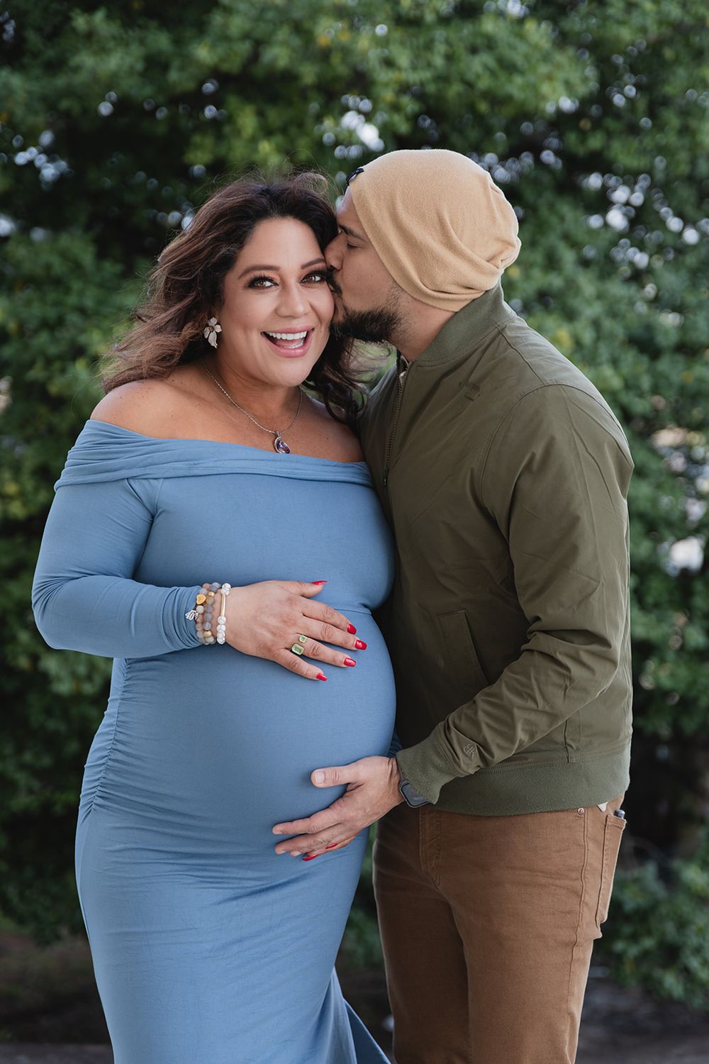 A couple embraces outdoors while wearing casual clothing, with a light blue dress and brown pants visible in the shots.